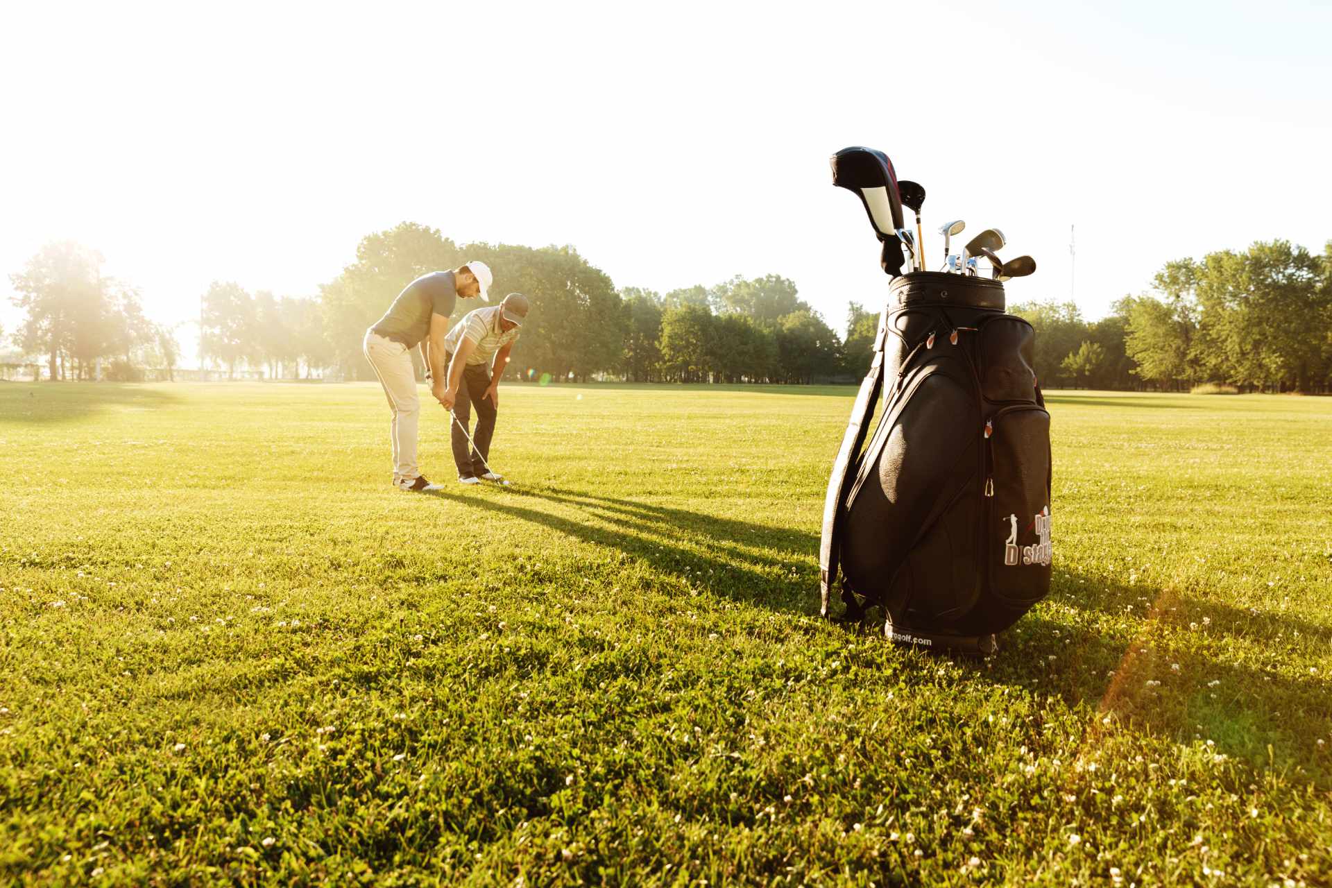 Image of golf ball on tee on grass.